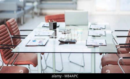 financial charts,calculators,notebook and pens laid out on the desktop before starting business negotiations.the photo has a empty space for your text Stock Photo