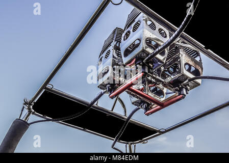 Metal burners of a hot air balloon, against blue sky, reflecting in the sunset, the balloon is hooked off the basket, Brorfelde, Denmark, August 14, 2 Stock Photo