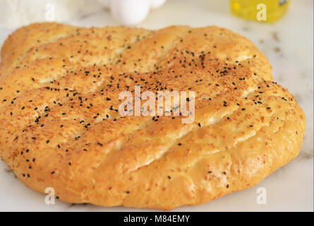 Turkish flat bread with sesame on marble countertop