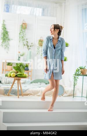 Woman waking up at home Stock Photo