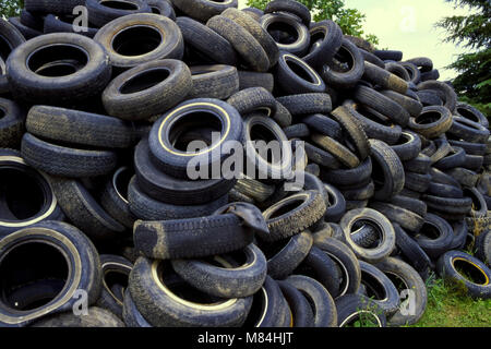 Stalk of used tires in wrecking yard Stock Photo