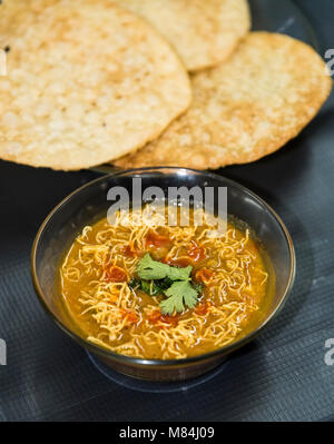 Dal Pakwan - The famous Sindhi cuisine- crispy deep fried flat bread with cooked spiced lentils (chanadal), mint chutney, tamarind-date chutney and on Stock Photo