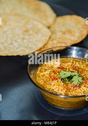 Dal Pakwan - The famous Sindhi cuisine- crispy deep fried flat bread with cooked spiced lentils (chanadal), mint chutney, tamarind-date chutney and on Stock Photo