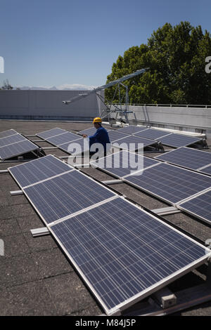 Male worker using digital tablet at solar station Stock Photo