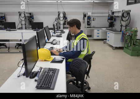 Male worker working on computer Stock Photo