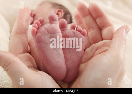 newborn baby boys tiny feet Stock Photo