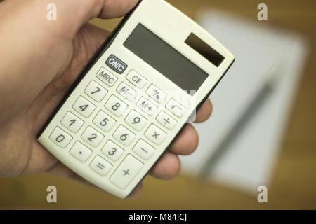 Man using calculator to count income and outcome Stock Photo