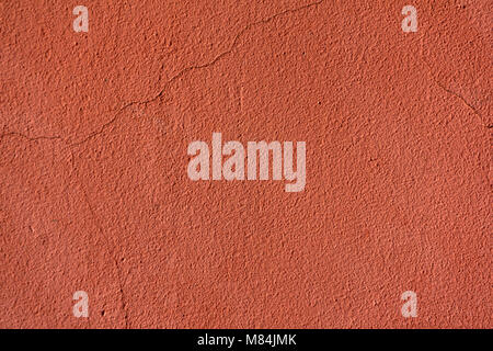 background, texture - orange rough plastered wall of a building with cracks Stock Photo