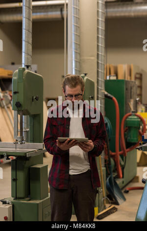 Male carpenter using digital tablet Stock Photo