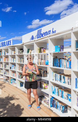 Woman near free beach library opened  at the Black Sea resort of Albena. Bulgaria Stock Photo