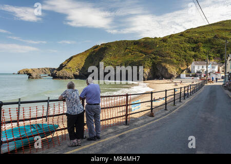 Holiday makers looking out over the beach at Llangrannog, Ceredigion in west Wales Stock Photo