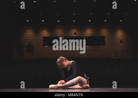 Ballet dancer wearing ballet shoe on stage Stock Photo