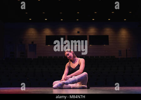 Ballet dancer wearing ballet shoe on stage Stock Photo