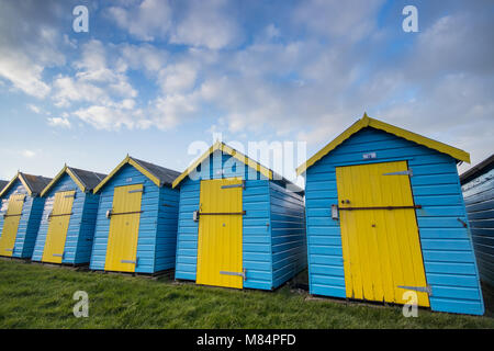 Beach huts at Felpham Greensward on the promenade near Bognor Regis, West Sussex, UK Stock Photo