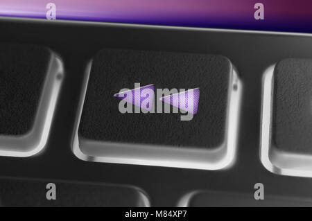 Close Up Of A Black Rewind Button Of A Black Remote Control With Backlight Stock Photo