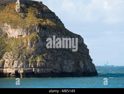 A ship passes the Great Orme at Llandudno, Conwy, Wales, UK. Stock Photo