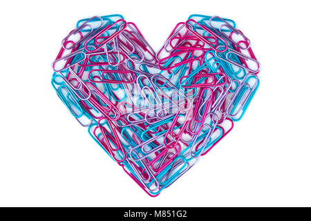 Blue and pink paper clips arranged in heart shape on white background Stock Photo