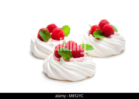 Mini  Pavlova meringue nests with berries and mint on isolated on white Stock Photo