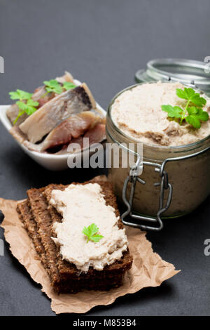 Forshmak  paste from herring on black stone background Stock Photo