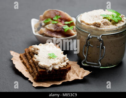 Forshmak  paste from herring on black stone background Stock Photo