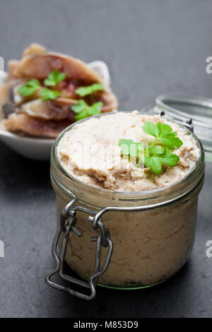 Forshmak  paste from herring on black stone background Stock Photo