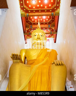 Thai beautiful art pattern of Thai temple door opening and Buddha in temple Suphanburi Province. Stock Photo