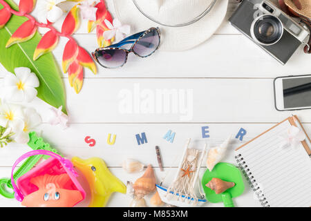 prepare accessories and travel items for summer, hat, sunglasses and vintage camera, kid toy on white wooden board, flat lay, top view background Stock Photo