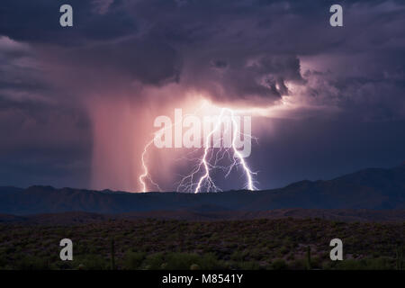 Lightning bolts strike the Four Peaks mountain range near Phoenix, Arizona during a summer monsoon thunderstorm Stock Photo