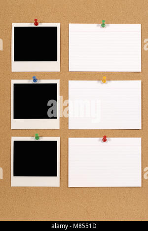 Cork notice or bulletin board with several blank instant camera photo prints and white office index cards. Space for copy. Stock Photo