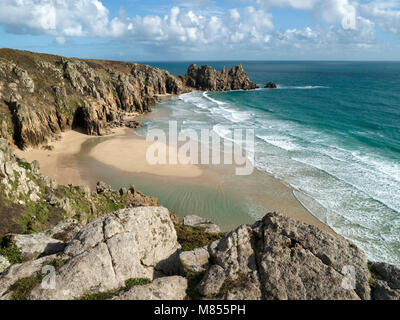 Deserted Pedn Vounder beach and Logan Rock headland as seen from South Cornwall Coastal path near Porthcurno, Cornwall, England, UK Stock Photo