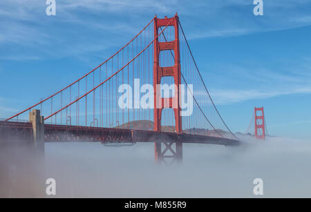 Thick low fog formed under the Golden Gate Bridge in San Francisco, California, United States, on an early spring morning. Stock Photo