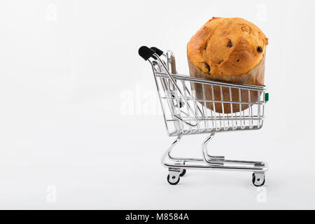 Traditional Italian Christmas sweet cake in a mini shopping cart on white background. Closeup Stock Photo