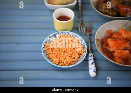 fresh hot Chinese take away with food in dishes and served on a table Stock Photo