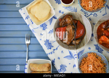 Chinese take away night with food in dishes cooked and served on a table Stock Photo