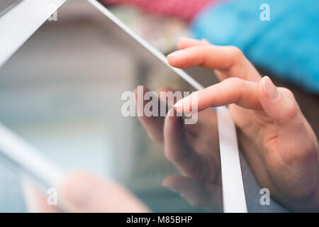 Female Hand Touching The Display Of A Tablet Computer Stock Photo