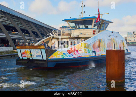 Passenger ferry leaving from Amsterdam Central Station to cross the IJ river, Amsterdam, Netherlands Stock Photo