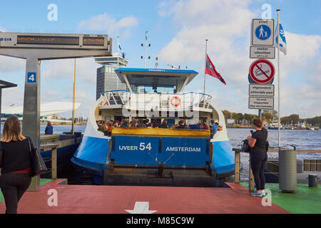 Packed passenger ferry leaving from Amsterdam Central Station to Overhoeks, Amsterdam, Netherlands Stock Photo