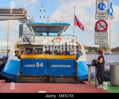 Packed passenger ferry leaving from Amsterdam Central Station to Overhoeks, Amsterdam, Netherlands Stock Photo