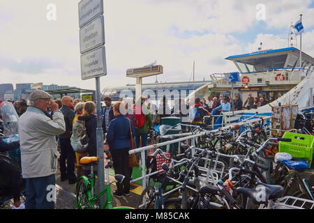 Foot passengers disembarking from ferry and bicycle park, Overhoeks, a new mixed use neighbourhood, Amsterdam, Netherlands Stock Photo