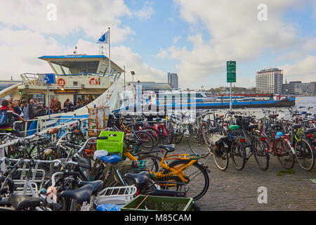 Foot passengers disembarking from ferry and bicycle park, Overhoeks, a new mixed use neighbourhood, Amsterdam, Netherlands Stock Photo