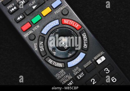 Brazil - March 13, 2018: Black smart tv remote control with the Netflix button. Stock Photo