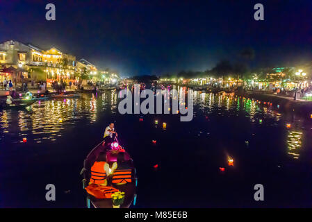 Dozens of colourful floating candles float down the river in Hoi An, Vietnam Stock Photo