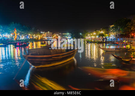 Boats float on the river at night at Hoi An, Vietnam Stock Photo