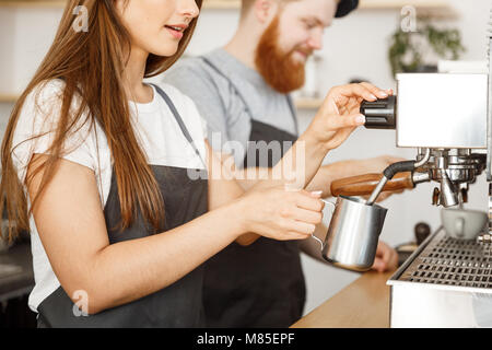 bearded barista in apron using shaker while working near coffee machine in  coffee shop Stock Photo by LightFieldStudios