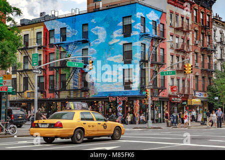 A yellow medallion NYC taxi crosses the junction of 1st & 9th in front of The Bean Coffee Shop  in the East Village , Manhattan . New York City ,USA Stock Photo