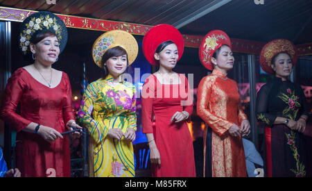 Vietnamese traditional singers on a boat. Using Sinh Tien (coin clapper ...