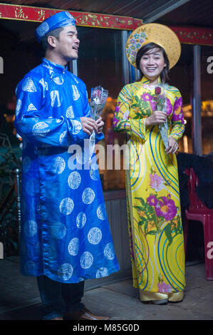 Vietnamese traditional singers on a boat. Using Sinh Tien (coin clapper ...
