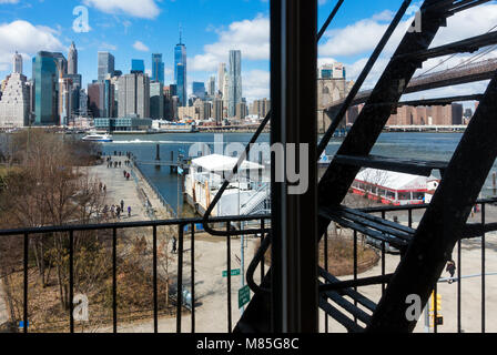 View of Lower Manhattan skyline and Dumbo ferry station on a sunny winter day Stock Photo