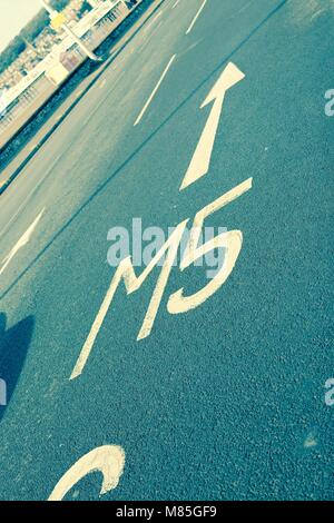 Road markings showing the way to the M5 motorway - filter applied Stock Photo
