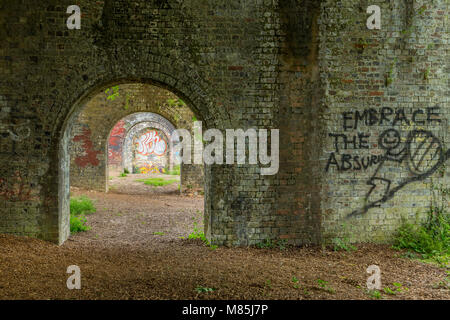 Graffiti on old brick railway arches, Stroud, England Stock Photo